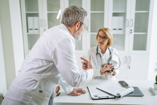 Senior doctors having consultation in a modern medical office - Powered by Adobe