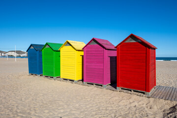 Colorful beach huts lining cullera beach in valencia