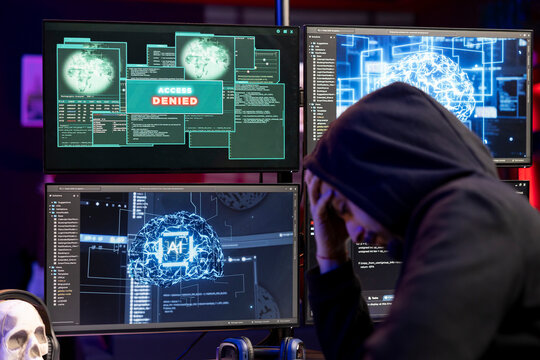 Dejected hacker upset after getting access denied message on PC when trying to steal sensitive information. Rogue programmer sad after failing to exploit system flaws using artificial intelligence