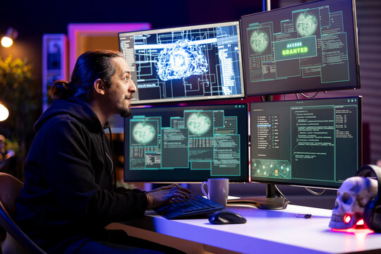 Happy hacker pleased after getting access granted message, evading security with stealth malware. Joyous man delighted after successfully making script hiding malicious code from detection systems