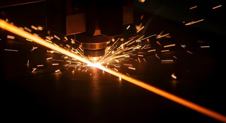Laser cutting machine creating sparks in industrial workshop  