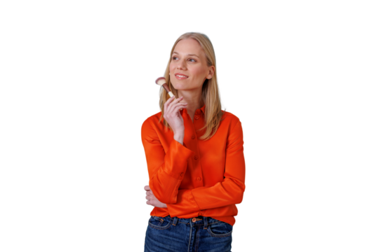 Smiling blonde woman stands holding a makeup brush, contemplating beauty rituals and self-care against a transparent background - Powered by Adobe