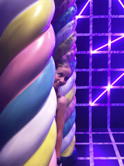 Girl peeking from giant marshmallow candy pillar