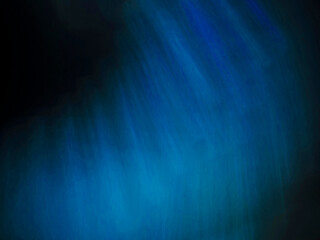 Colorful blue light leak on a black background for design and special effects. Random shape and form.
