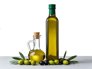 Still life featuring olive oil in bottles and olives with leaves on a gray surface against a white backdrop