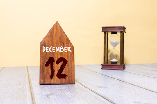 Wooden calendar December 12 on a white background close up. - Powered by Adobe
