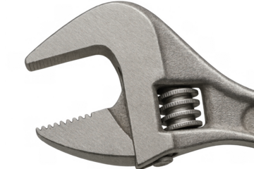 Adjustable wrench close-up with open jaws showing tool mechanism on transparent background, symbolizing repair and plumbing work