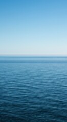 Obraz premium Expansive view of the ocean where the vast water meets the endless sky at a clear horizon, conveying peace and natural beauty ,water ,peaceful ,calm