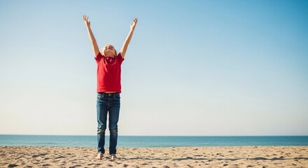 A happy young child stands on a sunny beach with arms raised toward the bright blue sky, celebrating freedom, joy, and a carefree summer moment.