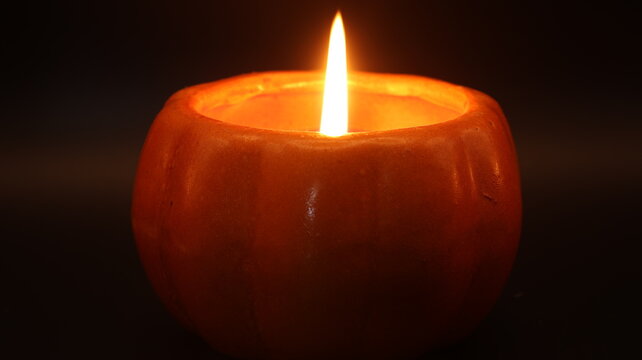Close-Up of a Single Burning Candle Flame on Dark Background