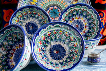 Decorative ceramic plates and bowls with classic Central Asian motifs