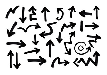 Collection of hand-drawn direction indicators with a black marker. Various shapes arrows pointing in different directions, on a white surface.