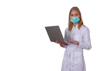 Healthcare professional wearing medical mask and lab coat, typing on laptop, working with medical technology