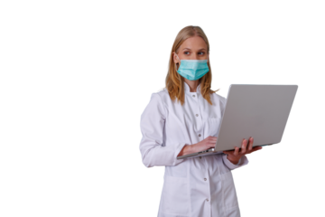 Female doctor or medical professional wearing face mask and lab coat, holding and typing on a laptop, using technology in healthcare