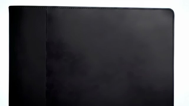 A close-up of a dark, rectangular surface with a subtle texture, ideal for graphic resources and background use with light reflection at the corner.