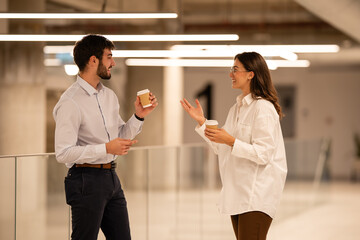 Business colleagues talking during coffee break in modern office