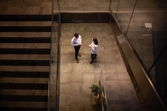Business colleagues talking during coffee break in modern office