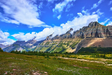 Fototapeta premium Majestic Mountain Range and Alpine Meadow Under Vibrant Sky in Pristine Wilderness