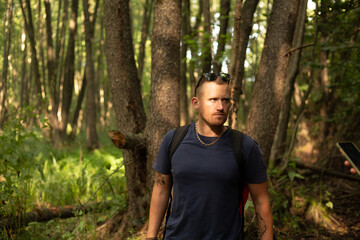 happy young caucasian man walking in the forest