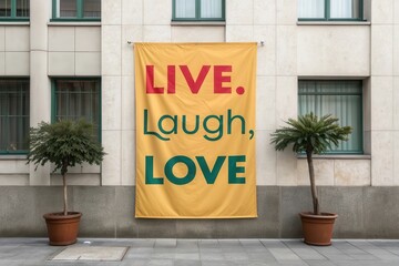 Inspirational Live Laugh Love Banner on a Building Wall