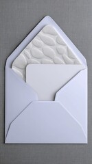 A white envelope is open, revealing a textured white liner and a blank white card inside, set against a grey background.
