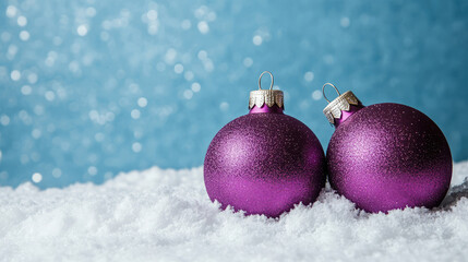 Three purple Christmas ornaments placed on a snowy surface, with a blue background.