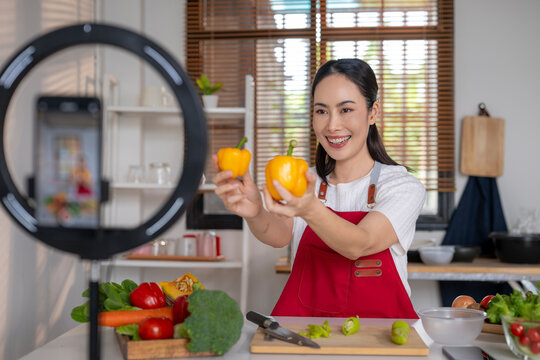 Woman livestreaming healthy cooking recipe using social media
