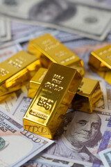 100 dollar bills with gold bars bullions. Wealth saving concept