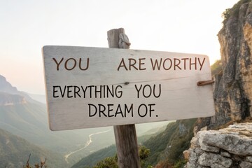 Wooden sign with uplifting message about dreams