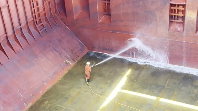 rew cleaning bulk carrier hold after discharging petroleum coke using seawater, chemicals, and brushes. sea water 32