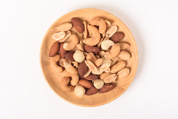 Mixed nuts consisting of almonds, cashews and peanuts, roasted with salt. Healthy snack on white background.