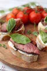 Bruschettas with roast beef served on table, closeup