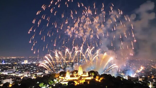 Night scene over a city with vibrant fireworks illuminating a temple on a hilltop