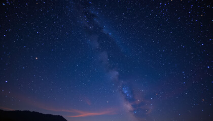 Naklejka premium Stunning view of starry night sky filled with countless stars, showcasing Milky Way galaxy. deep blue hues create serene and tranquil atmosphere, perfect for stargazing and reflection