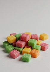 An assortment of brightly colored, sugary, square bubble gum pieces arranged haphazardly on a clean background, highlighting the sweet confectionery texture ,cube ,assortment ,sticky
