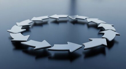A circular arrangement of arrows on a reflective surface, with a gradient from dark to light grey, creating a sense of direction and movement.