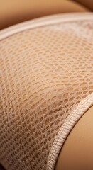 Close-up captures the delicate texture of beige, net-like fabric draped smoothly curves.