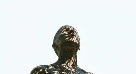 A contemplative gaze upward towards tropical sun casting shadows on serene face.