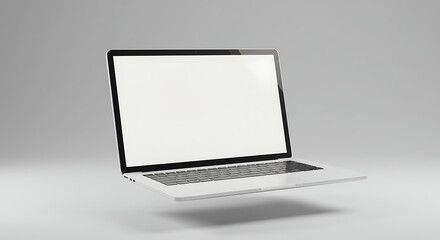 A modern laptop computer with a blank screen floats against a grey background.