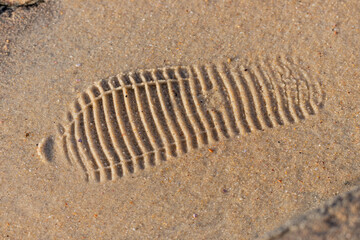 A shoe print in the sand on a beach in Rio de Janeiro.