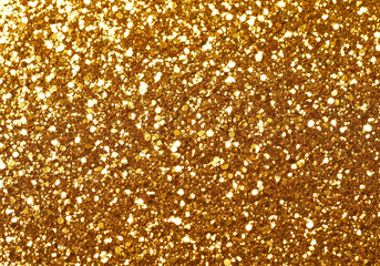 Sparkling gold glitter texture background abstract shimmering particles festive celebration backdrop.