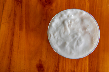 Top view cold milk cream foam on coffee