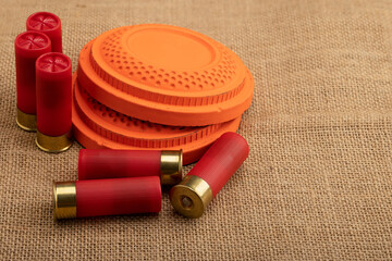 Clay shooting target with shotgun shell on sackcloth background , Clay pigeon shooting game © Suttiwan