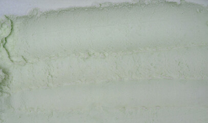 Close-up of pale Coconut ice cream with smooth, creamy texture and visible scoop marks.
