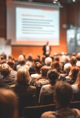 "Speaker on Stage at Conference Meeting Event. Presenter at Business Seminar Photo. Audience Watching a Manager Presentation. Blurred Image of Lecturer Presenting To Audience During Speech. "