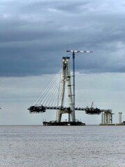 Fototapeta premium Cable-Stayed Bridge Under Construction Over River