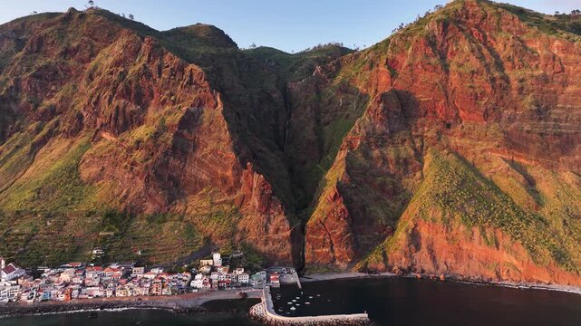 Drone establisher toward Pa&uacute;l do Mar seaside town and waterfall on Madeira