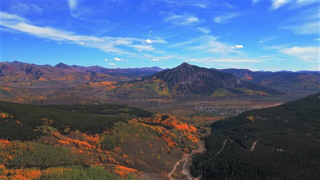 Crested Butte ski resort small Colorado Rocky Mountains down town Main Street drone aerial fall autumn Quaking Aspen Trees leaf peeping season daytime blue skies clouds Coal Creek Kebler Pass circle