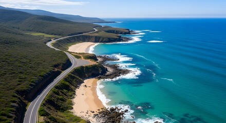 Scenic coastal road winding along turquoise ocean and sandy beach