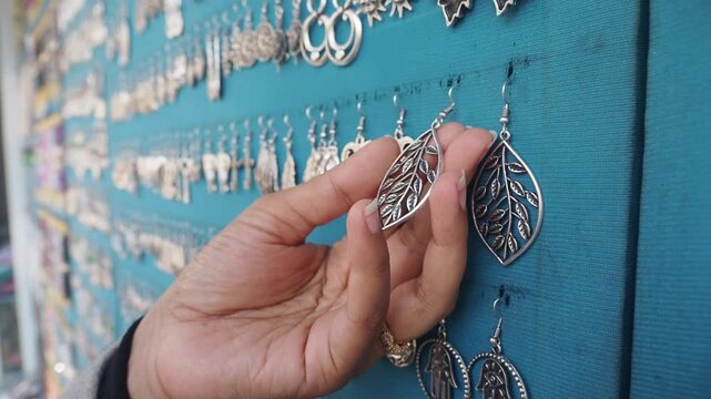 Exploring unique silver earrings at a vibrant market